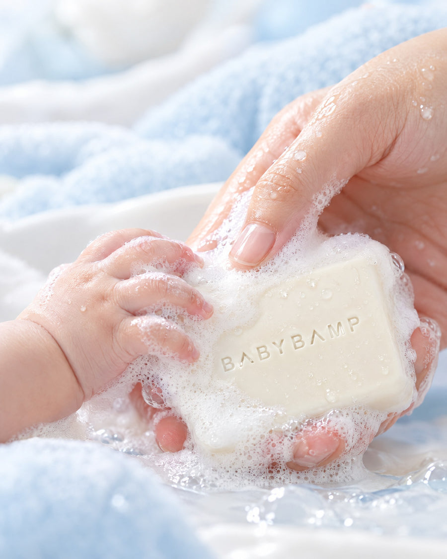 A baby's hand and a parent's hand in soft lather on the BabyBamp bar